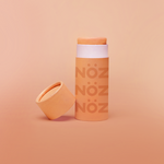 Load image into Gallery viewer, Open tube of Nöz sunscreen in orange 
